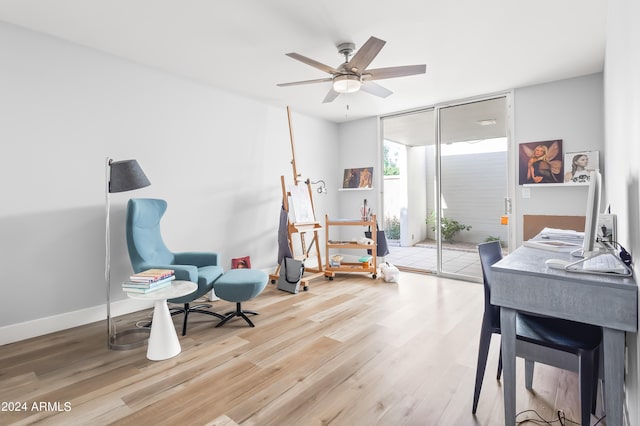 office with ceiling fan and light hardwood / wood-style floors