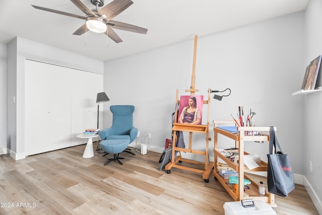 sitting room featuring light wood-type flooring and ceiling fan