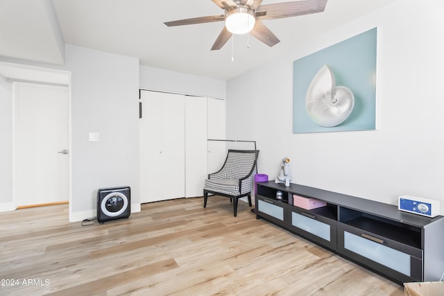 sitting room with light hardwood / wood-style floors and ceiling fan