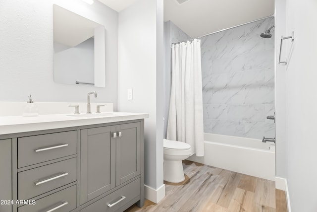 full bathroom with hardwood / wood-style flooring, vanity, toilet, and shower / bath combo with shower curtain