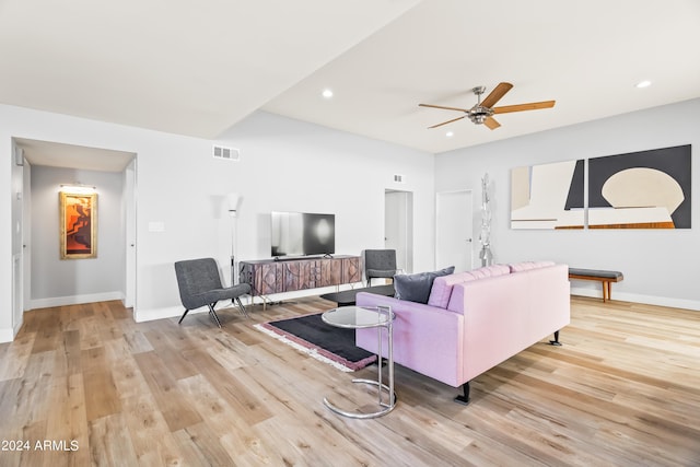 living room with ceiling fan and light hardwood / wood-style flooring