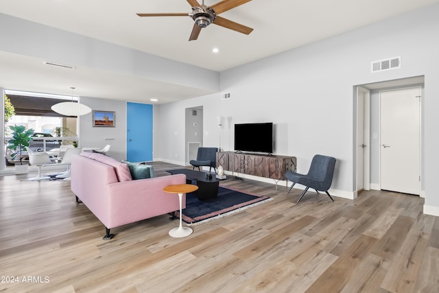 living room featuring ceiling fan and light hardwood / wood-style flooring