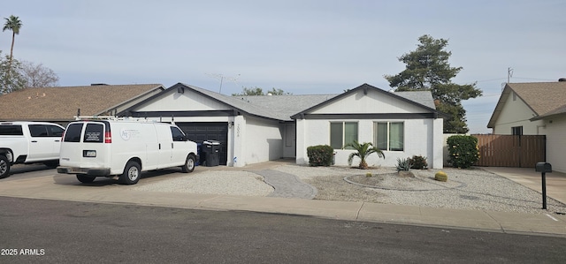 ranch-style home with a garage and concrete driveway