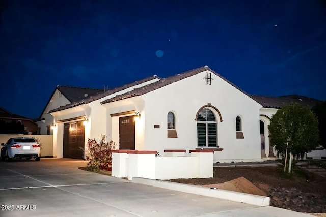 mediterranean / spanish home with a garage