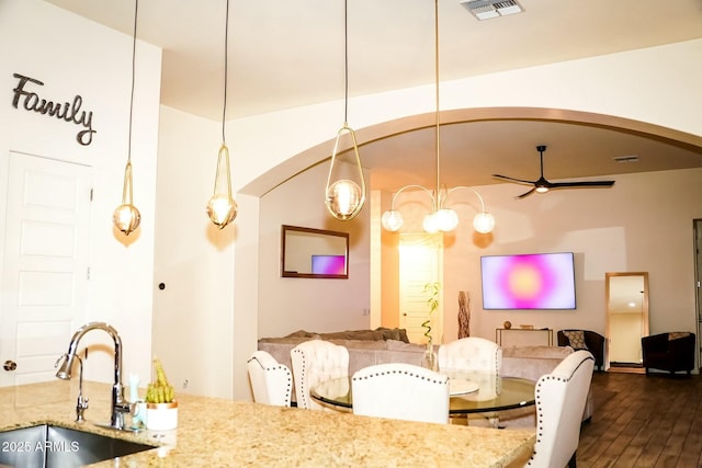 interior space with sink, hardwood / wood-style flooring, and ceiling fan