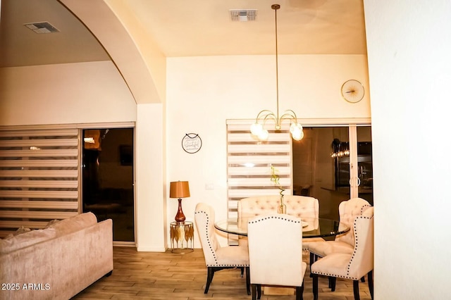 dining room featuring hardwood / wood-style floors and a notable chandelier