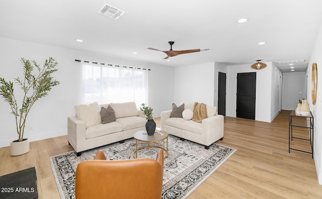 living room with ceiling fan and light hardwood / wood-style floors