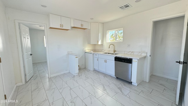 kitchen featuring white cabinets, sink, and stainless steel dishwasher