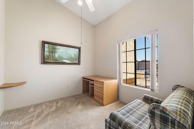 living area with light carpet, high vaulted ceiling, and ceiling fan