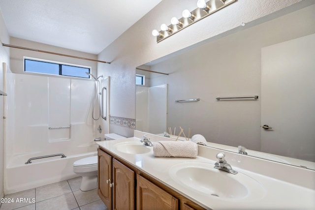 full bathroom featuring toilet, vanity, tile patterned floors, and shower / washtub combination