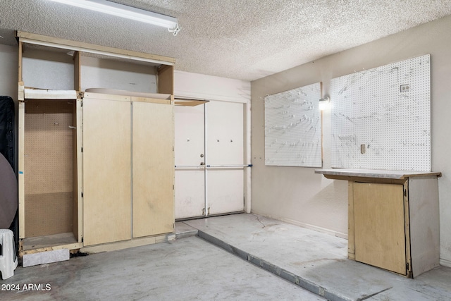 interior space featuring a textured ceiling and a workshop area