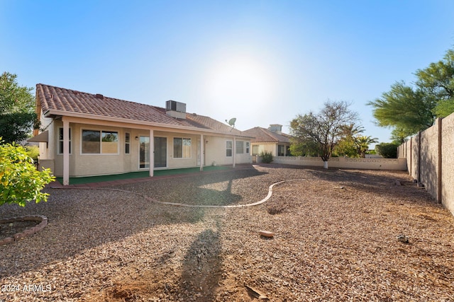 back of house featuring central AC