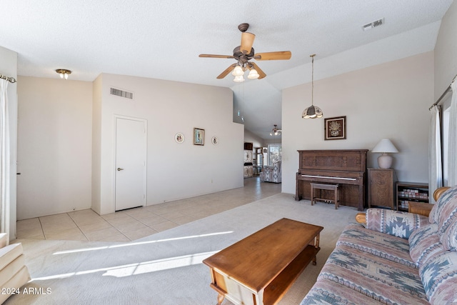 living room featuring plenty of natural light, ceiling fan, light tile patterned floors, and vaulted ceiling