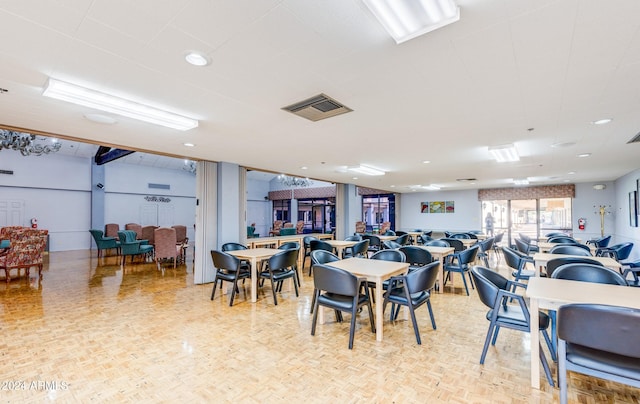 dining space with light parquet flooring