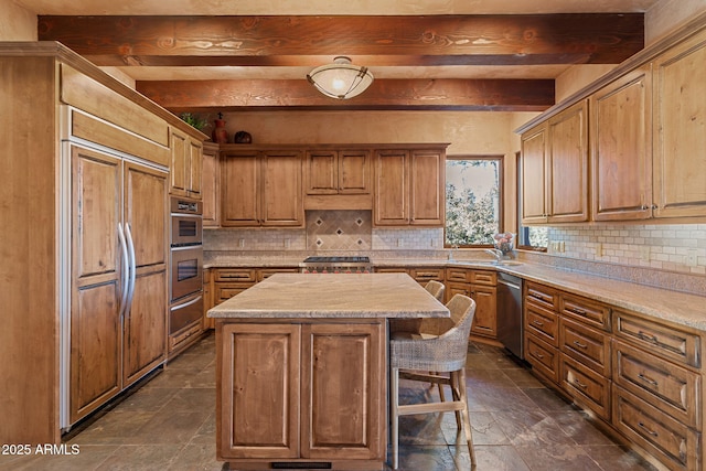 kitchen featuring paneled built in refrigerator, beamed ceiling, dishwasher, and a kitchen island