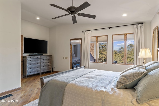 bedroom featuring ceiling fan, light hardwood / wood-style flooring, and vaulted ceiling