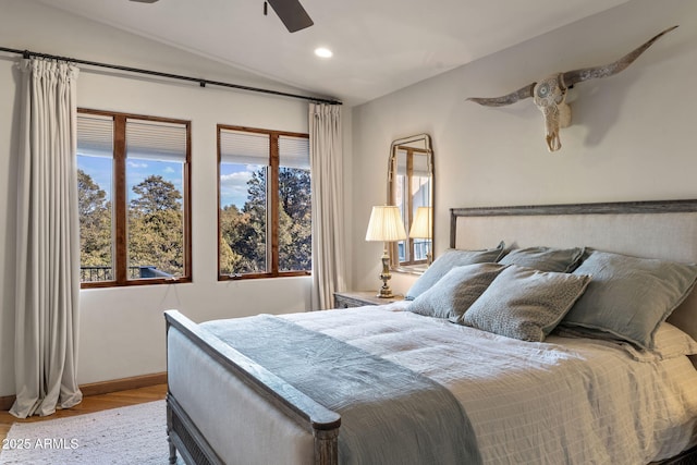 bedroom featuring lofted ceiling, ceiling fan, and light hardwood / wood-style floors