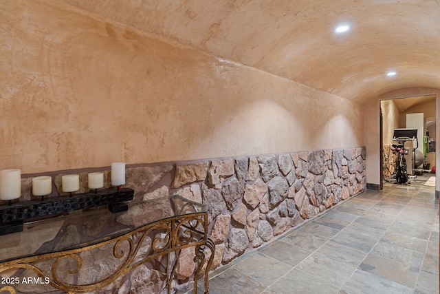 interior space with vaulted ceiling and brick ceiling