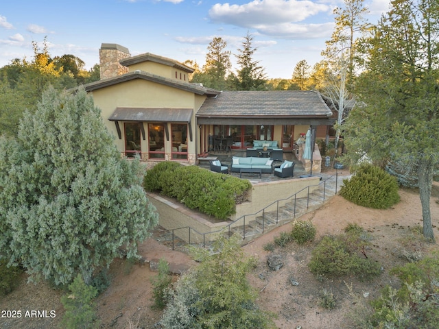 back of property featuring an outdoor hangout area