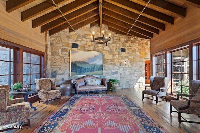 living room with high vaulted ceiling, beam ceiling, and a notable chandelier