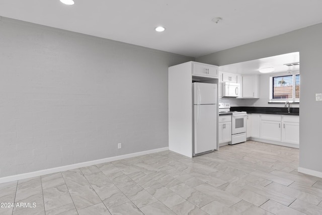 kitchen featuring white cabinets, white appliances, and sink