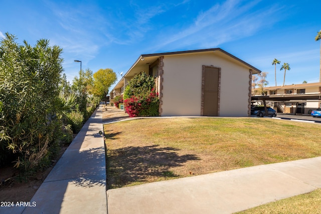 view of property exterior with a lawn