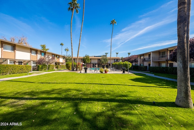 view of property's community with a lawn