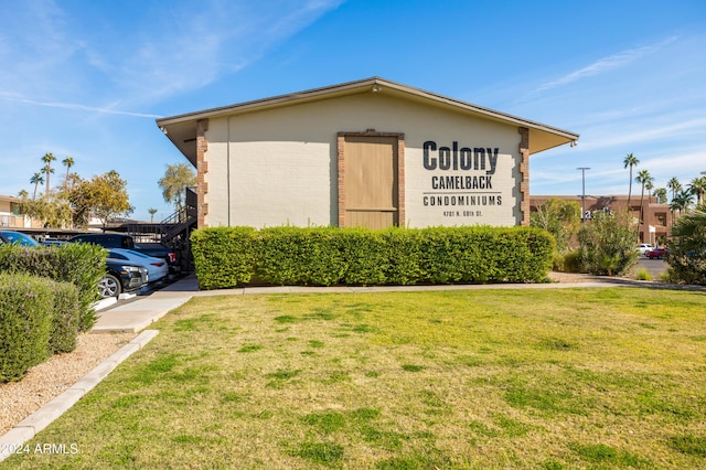 4701 N 68th St Unit 248, Scottsdale, AZ 85251 - view of side of home featuring a lawn and brick siding