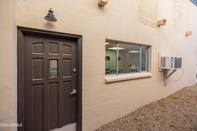 4701 N 68th St Unit 248, Scottsdale, AZ 85251 - entrance to property featuring an AC wall unit and stucco siding