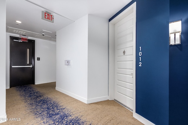 hallway with carpet flooring and elevator