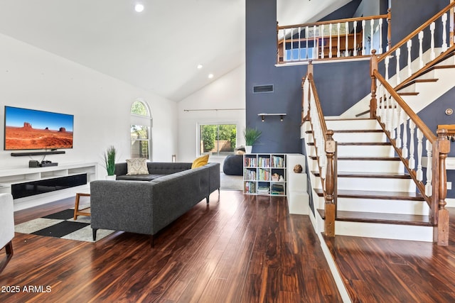 living room featuring high vaulted ceiling and hardwood / wood-style flooring