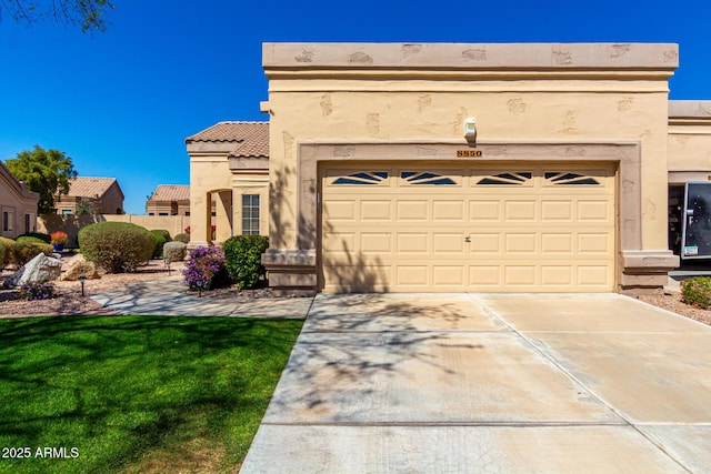 view of front of home featuring stucco siding, concrete driveway, a front yard, and a tiled roof