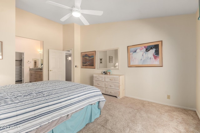 bedroom featuring baseboards, ensuite bath, ceiling fan, vaulted ceiling, and carpet flooring