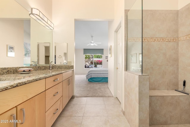 bathroom with tile patterned floors, a ceiling fan, connected bathroom, double vanity, and walk in shower