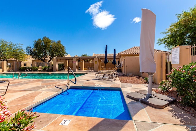 community pool featuring a patio and fence