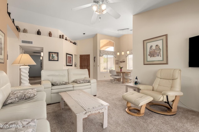 living room with visible vents, carpet floors, high vaulted ceiling, and ceiling fan