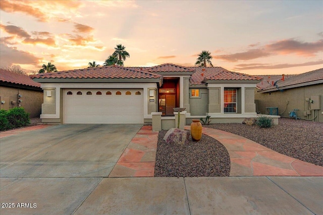 mediterranean / spanish house featuring a garage