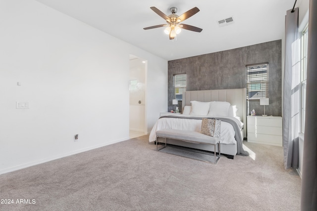 bedroom featuring light carpet and ceiling fan