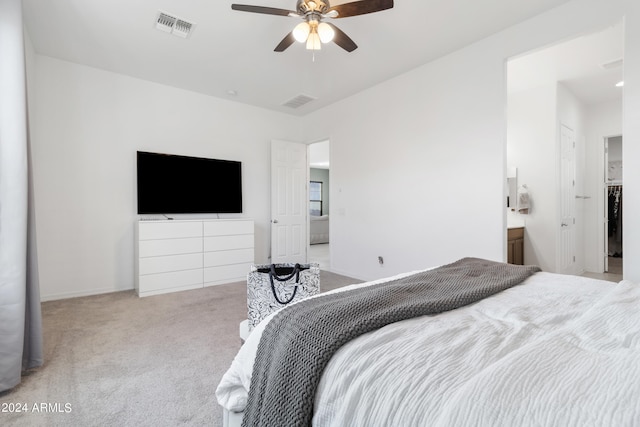 carpeted bedroom featuring connected bathroom and ceiling fan