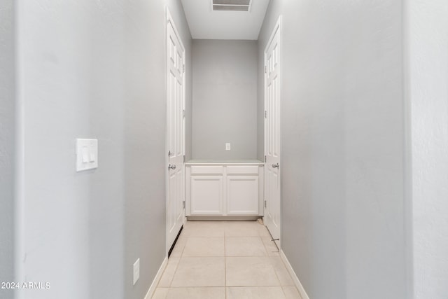 hall with light tile patterned floors