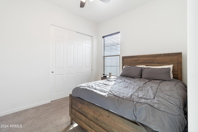 carpeted bedroom featuring a closet and ceiling fan