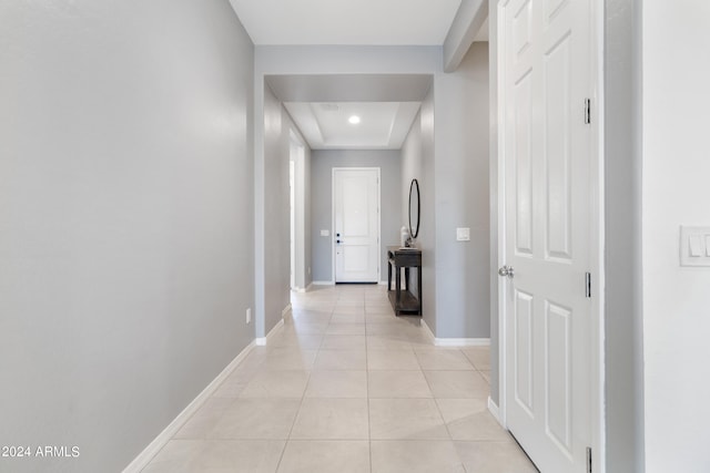 hall featuring light tile patterned flooring