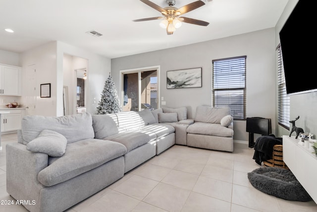 living room featuring light tile patterned flooring and ceiling fan