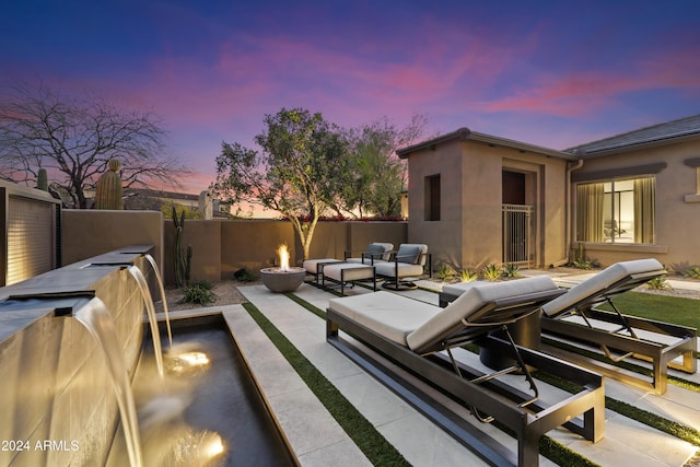 view of patio terrace at dusk