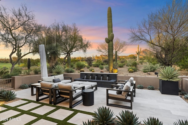 patio terrace at dusk featuring outdoor lounge area