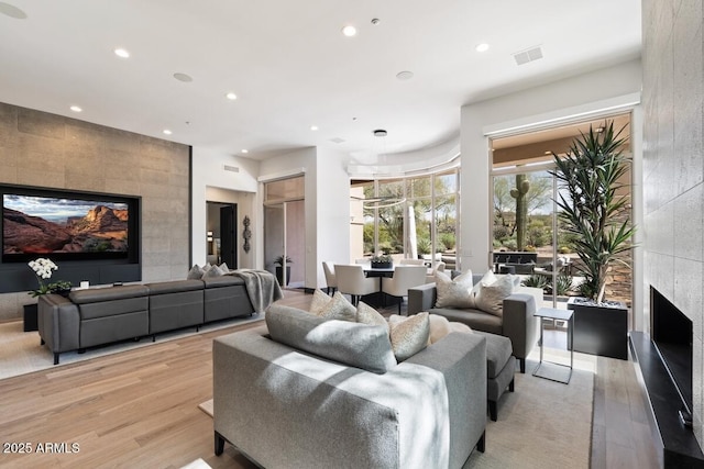 living room with a fireplace and light hardwood / wood-style floors