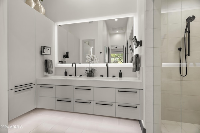 bathroom featuring vanity and tiled shower