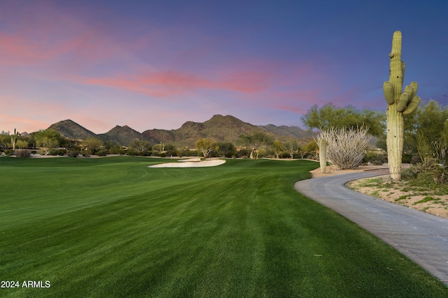 surrounding community featuring a yard and a mountain view