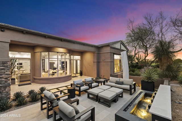 patio terrace at dusk with an outdoor hangout area