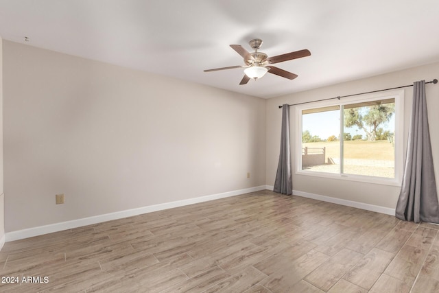 empty room featuring light hardwood / wood-style flooring and ceiling fan